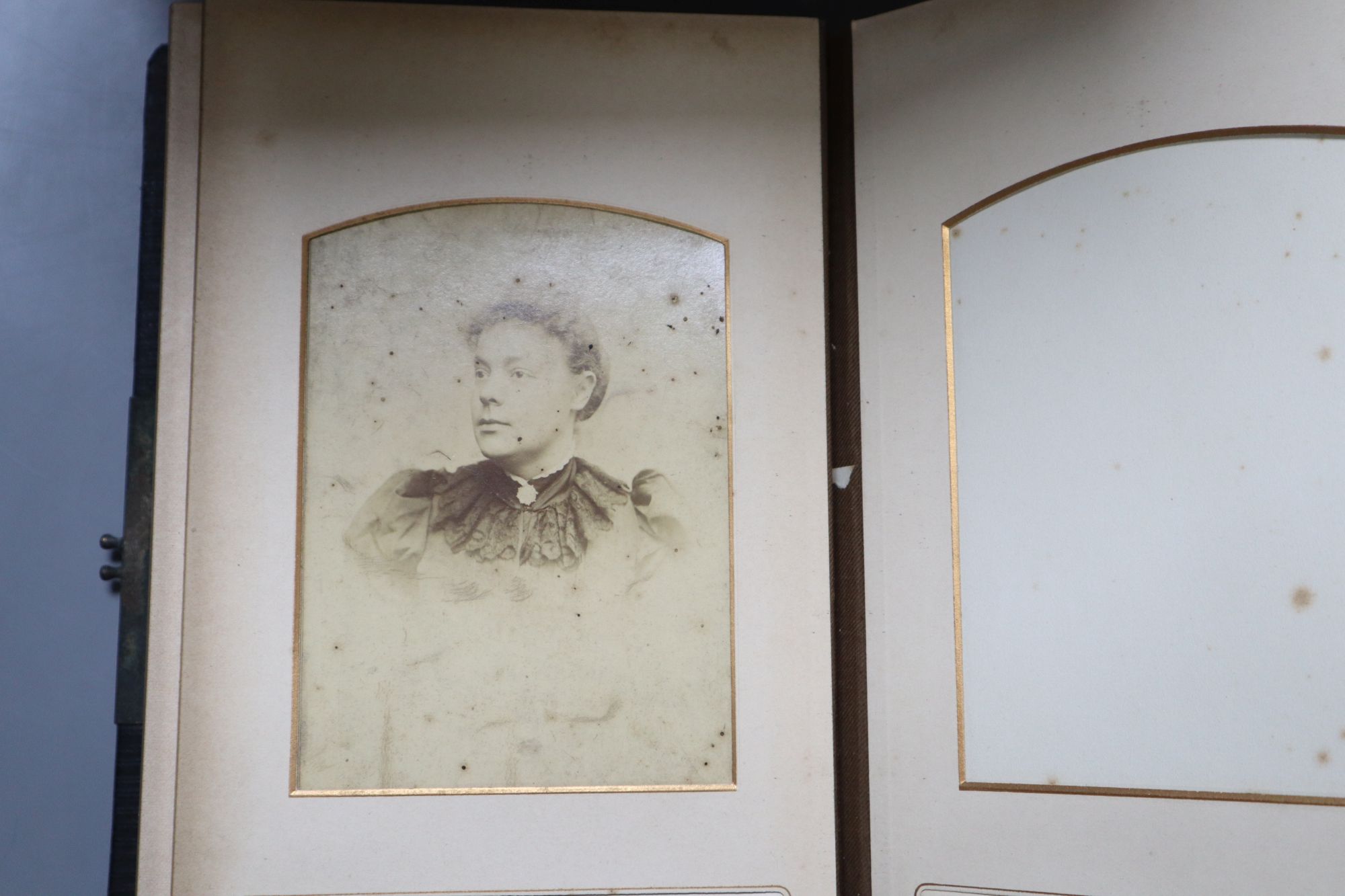 A Victorian album of cabinet portraits and one other sparsely mounted album (2)